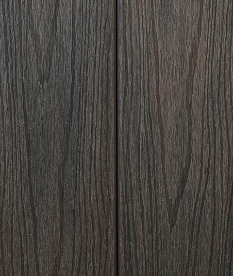 Two Modern Deck Classic Solid boards in Walnut, a dark brown woodgrain-embossed composite surface shown close up