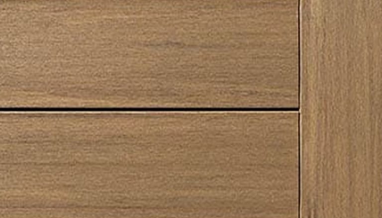 Close-up of TimberTech Vintage decking in Weathered Teak, a light tan brown with fine grain, boards meeting a fascia board