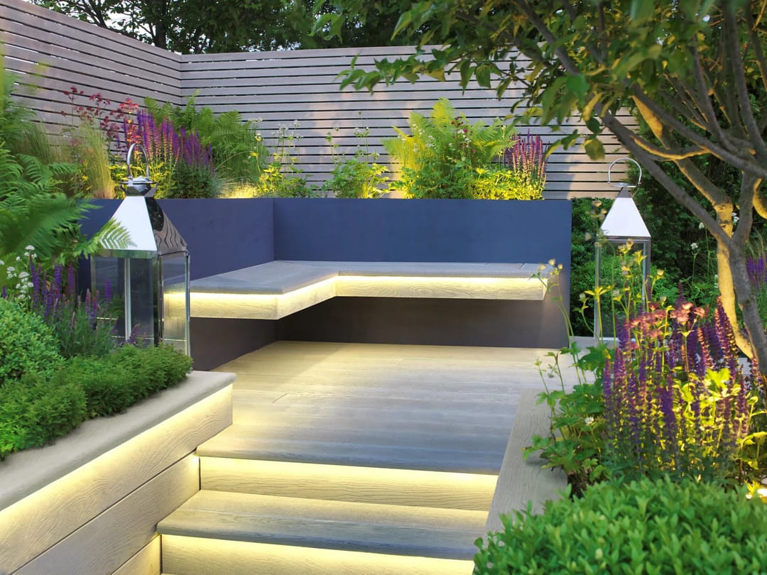 Light grey Smoked Oak garden steps and built-in bench lit by LED strips, among purple salvias and lanterns