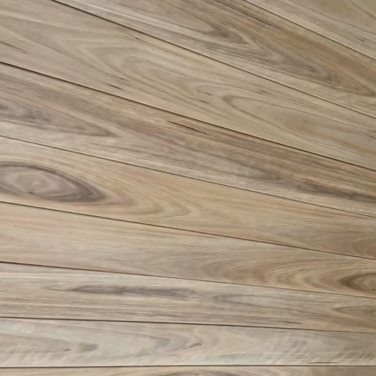 Diagonal close-up of Origin composite deck boards showing the realistic printed eucalypt grain and board gaps