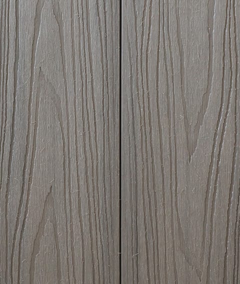 Two Modern Deck Classic Solid boards in Antique Grey, a mid grey woodgrain-embossed composite surface shown close up