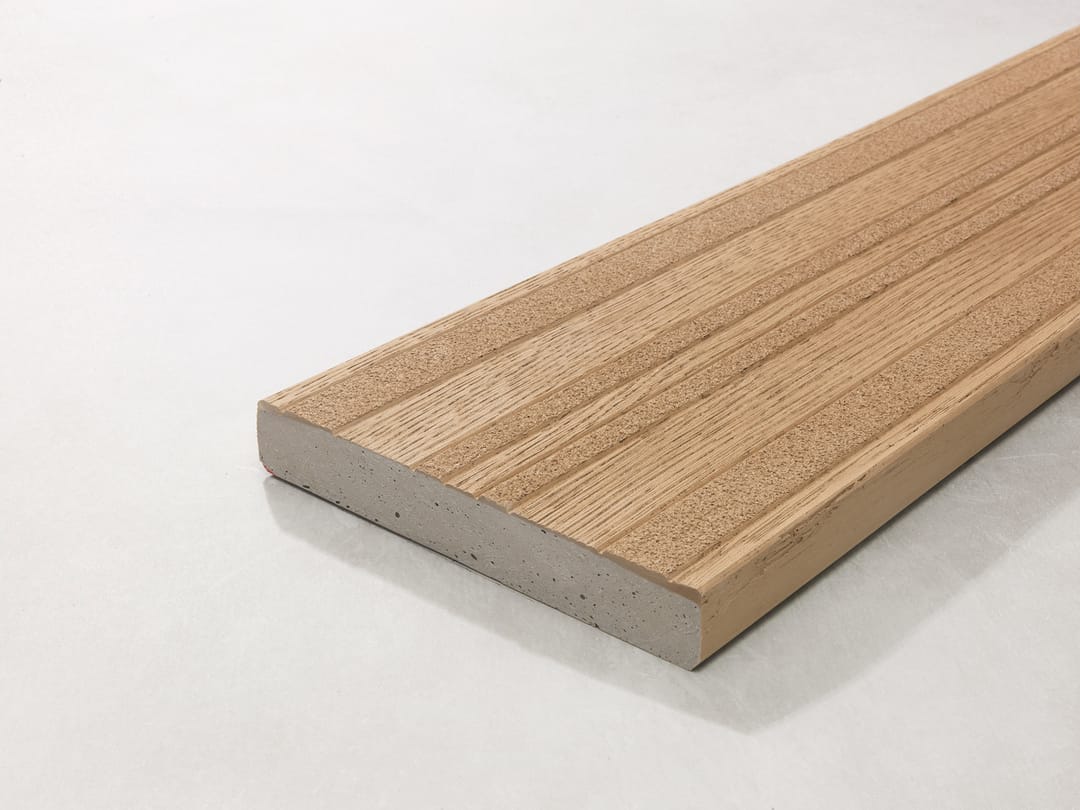 Single Millboard Lasta-Grip board in Golden Oak, honey tan with its grooved anti-slip surface, shown at an angle