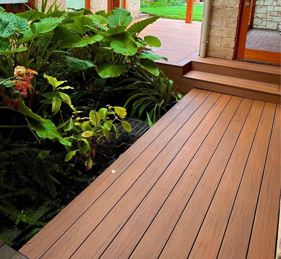 Garden walkway and steps in CleverDeck Xtreme Desert Oak boards edged by lush tropical planting