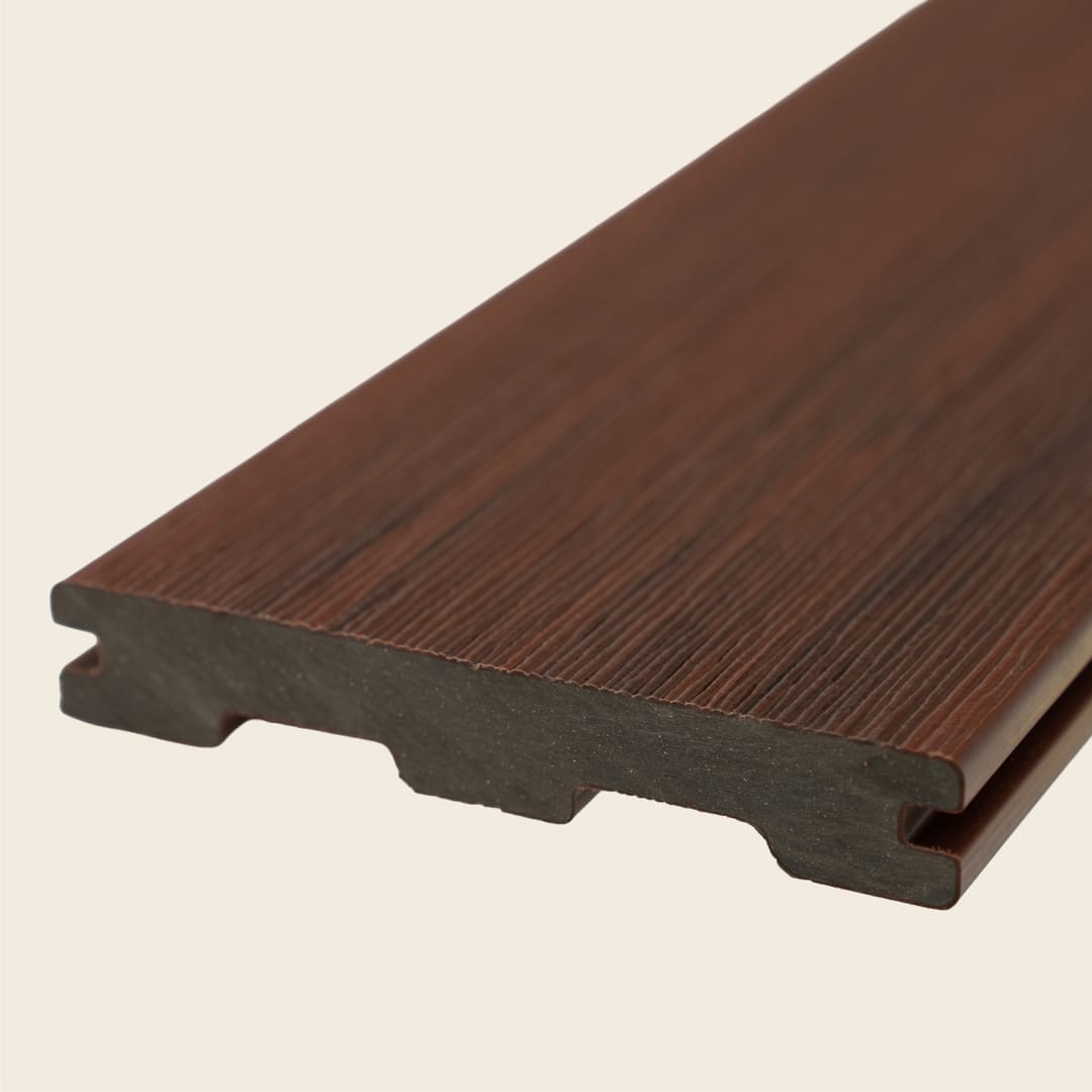 WoodEvo HOME grooved composite decking board in Barossa, a deep red-brown with fine grain, shown end-on on a cream background