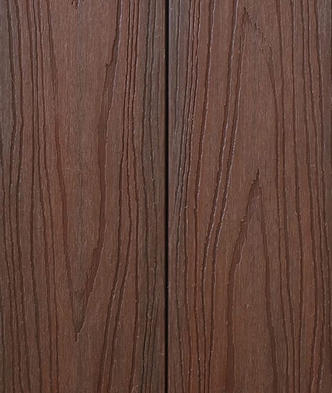 Two Modern Deck Classic Solid boards in Blue Gum, a red-brown woodgrain-embossed composite surface shown close up