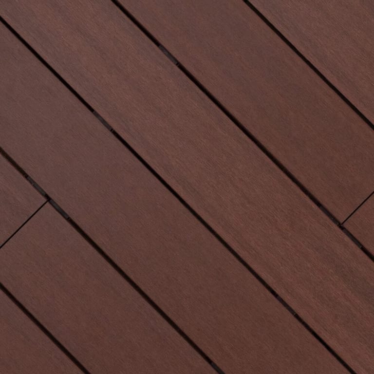 Close-up of Outdure ResortDeck Byron composite deck boards laid on the diagonal, in deep red-brown