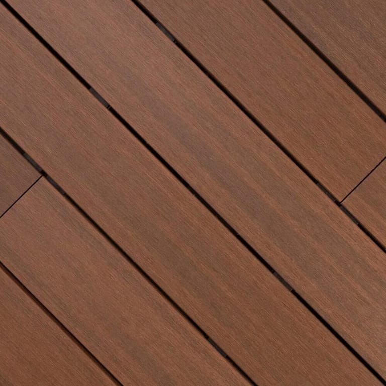 Close-up of Outdure ResortDeck Caribbean composite deck boards laid on the diagonal, in reddish timber brown