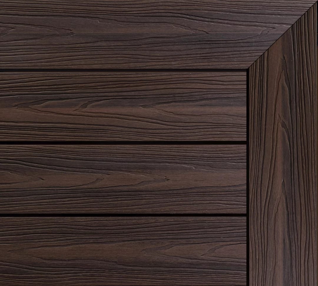 Ekodeck Designer Series composite decking boards in Estate Brown, a deep dark brown, with a mitred edge board