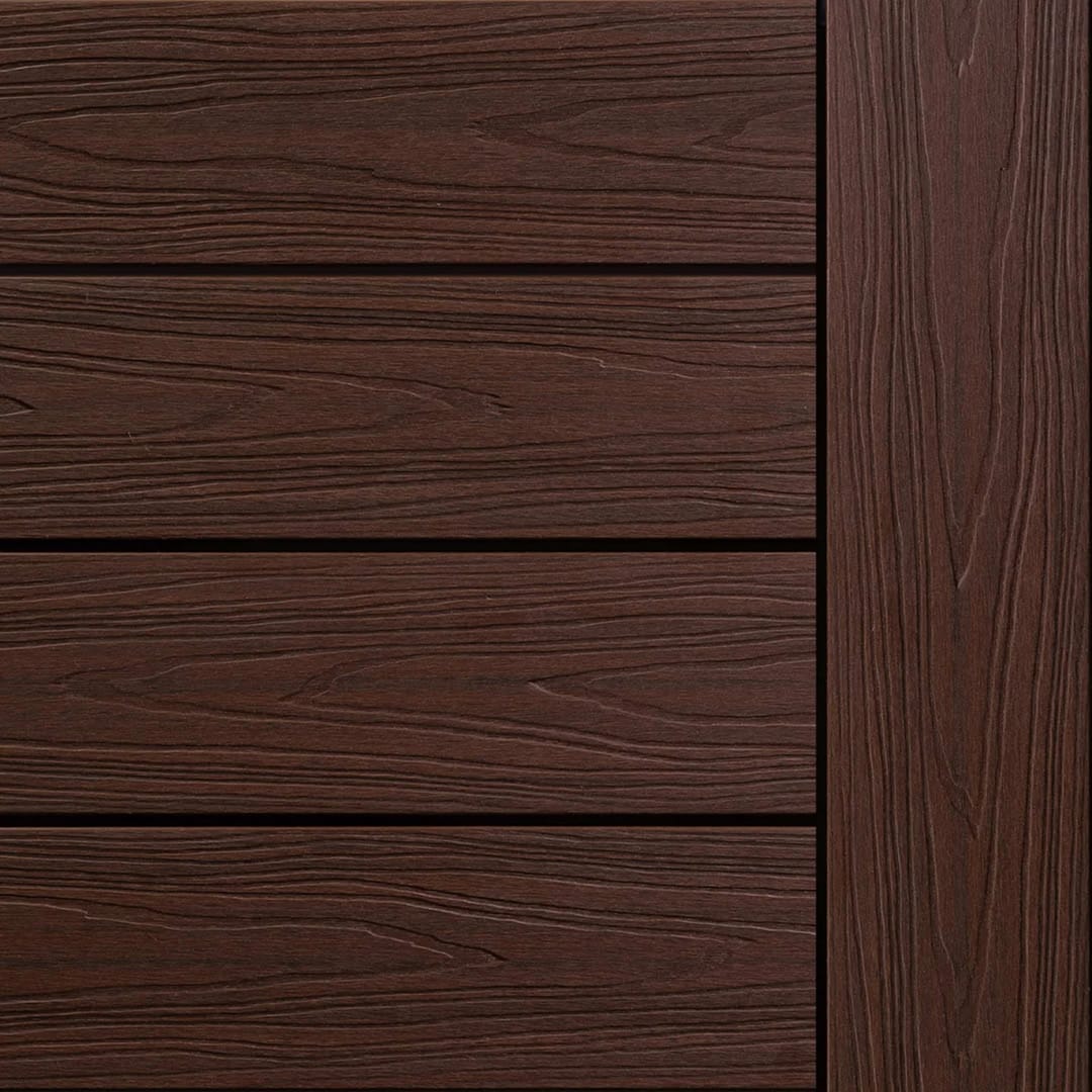 Ekodeck Flame Fighter composite decking boards in Redgum, a deep red-brown, laid with an edge board