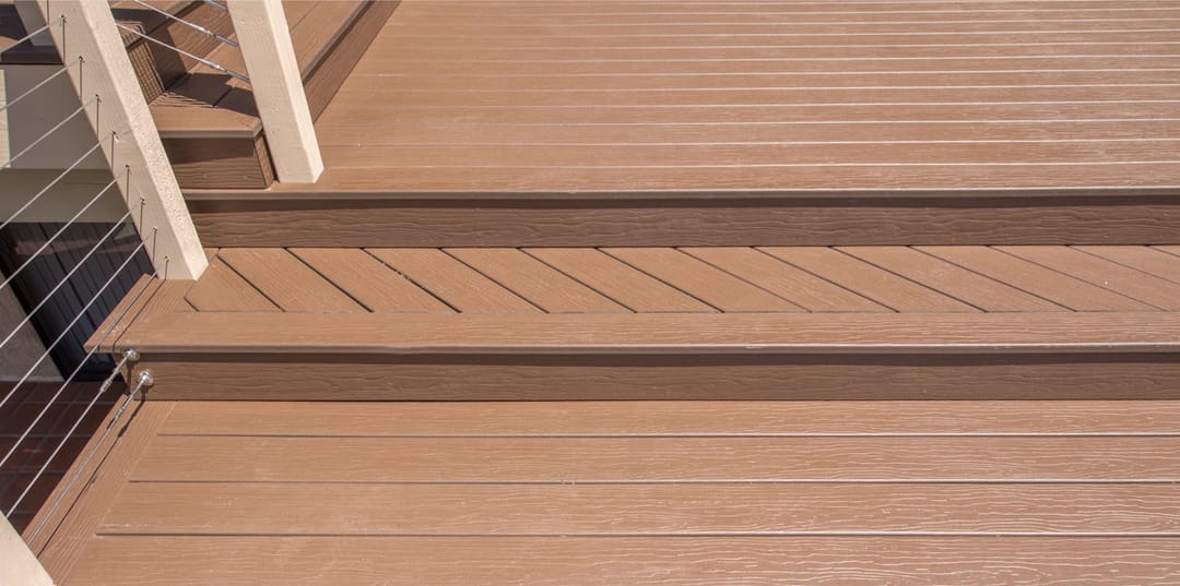 Close-up of MoistureShield Vision Cold Brew boards on deck steps, a warm mid brown with fine grain
