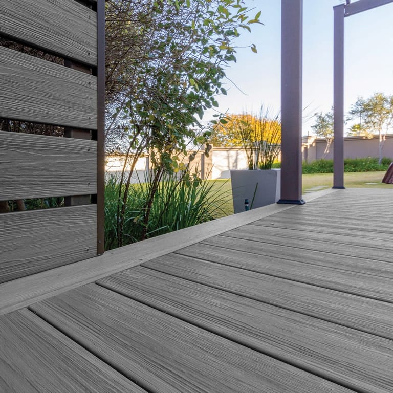 Covered patio deck in Eva-Last Infinity Concrete Grey with a slatted screen, steel posts and a garden view