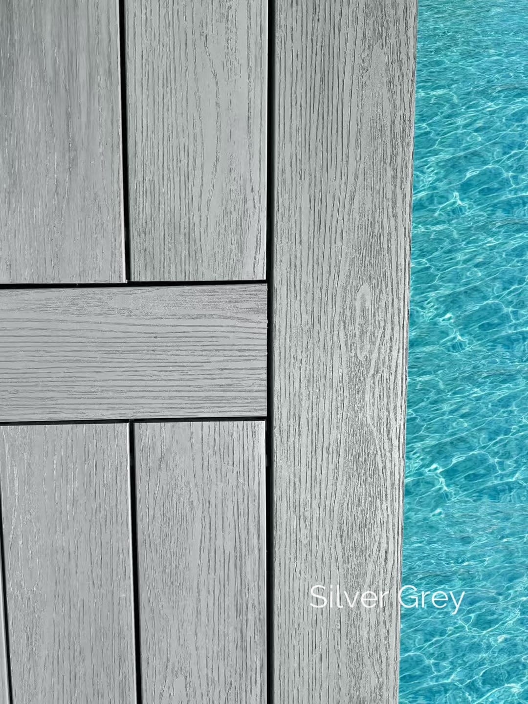 Close-up of Evertex Pioneer Silver Grey boards laid in a picture-frame pattern at the edge of a blue swimming pool