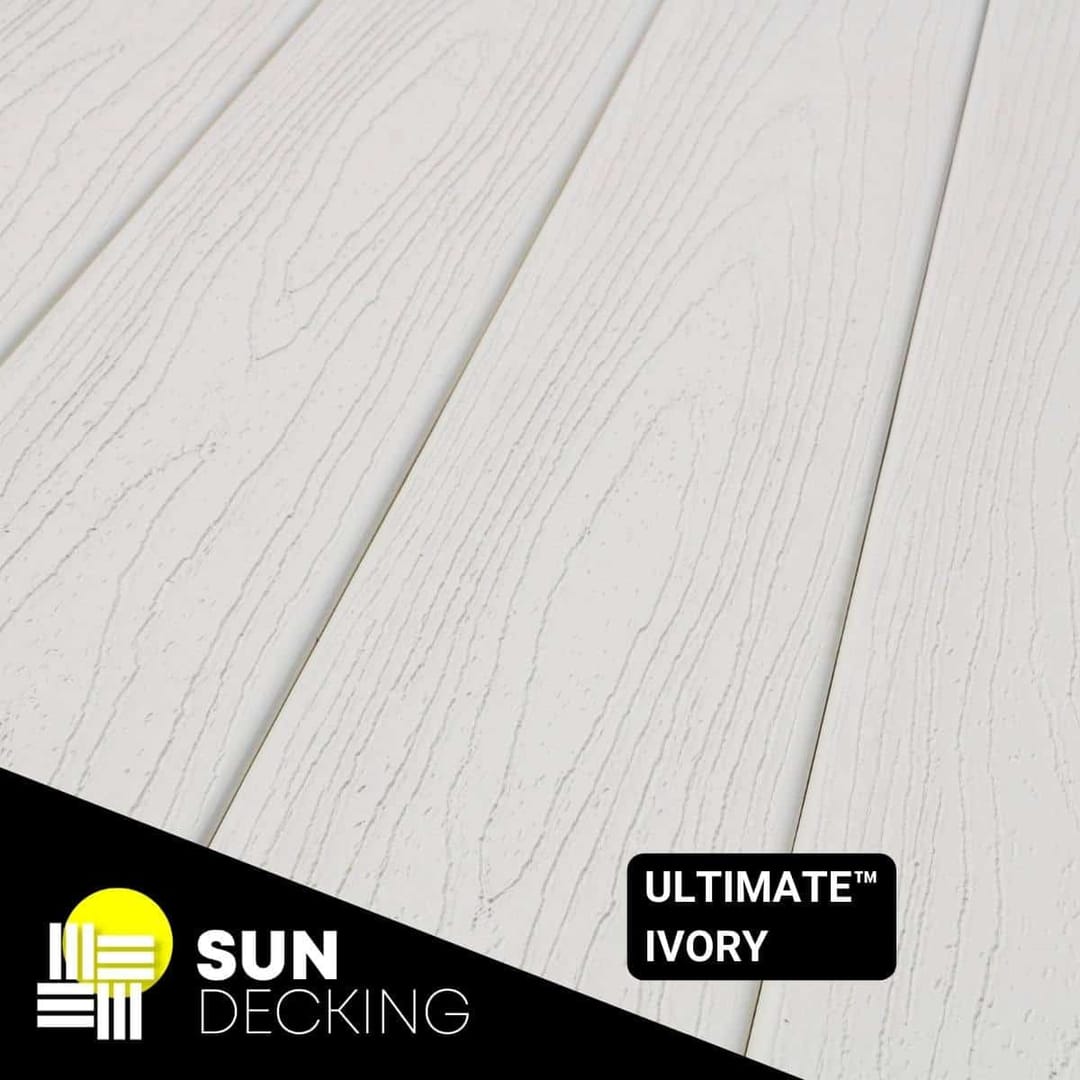 Angled close-up of Sun Decking Ultimate composite boards in Ivory, a off-white deep-embossed woodgrain, with the Sun Decking logo