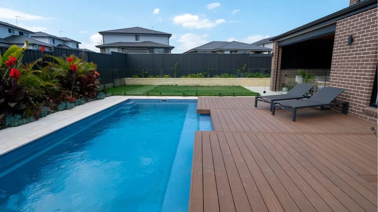 Pool surround in CleverDeck Xtreme Rustic Merbau 138 mm boards beside a lap pool and sun loungers in a Campbelltown backyard