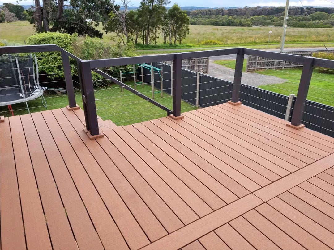 Rural backyard deck in CleverDeck Original Walnut with a dark steel and wire balustrade overlooking paddocks