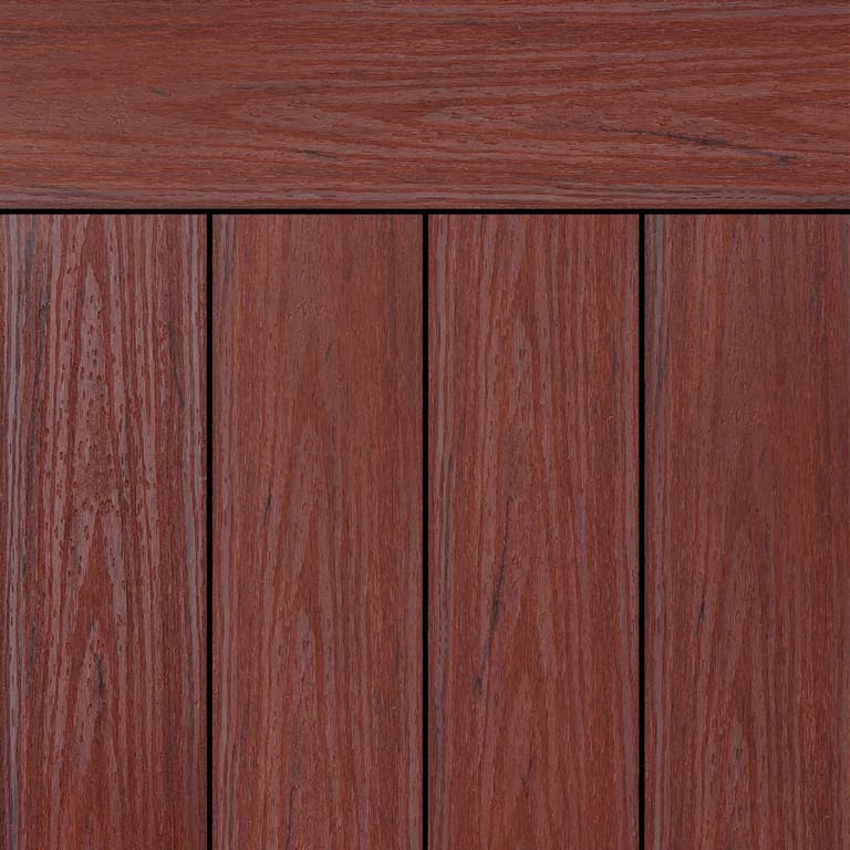 OneDeck SnapDeck Ironbark Ember PVC deck boards laid side by side under a matching fascia, in red-brown