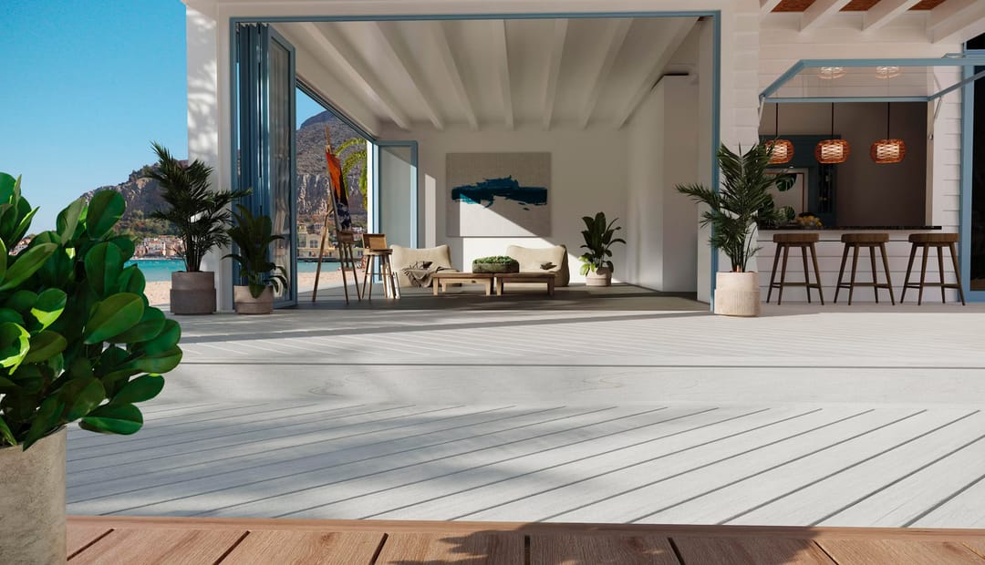 Pale Lineage Salt Flat deck running from an open-plan living room out to a beachfront terrace with lounge chairs