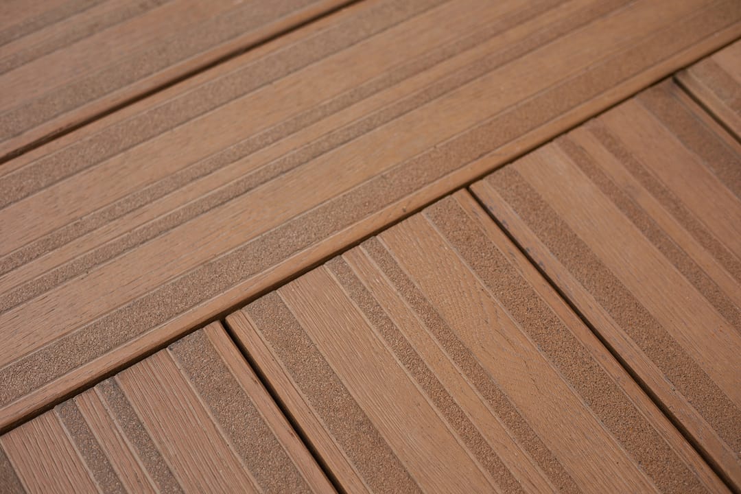 Close-up of laid Lasta-Grip decking in Coppered Oak showing the ribbed slip-resistant strips along each board