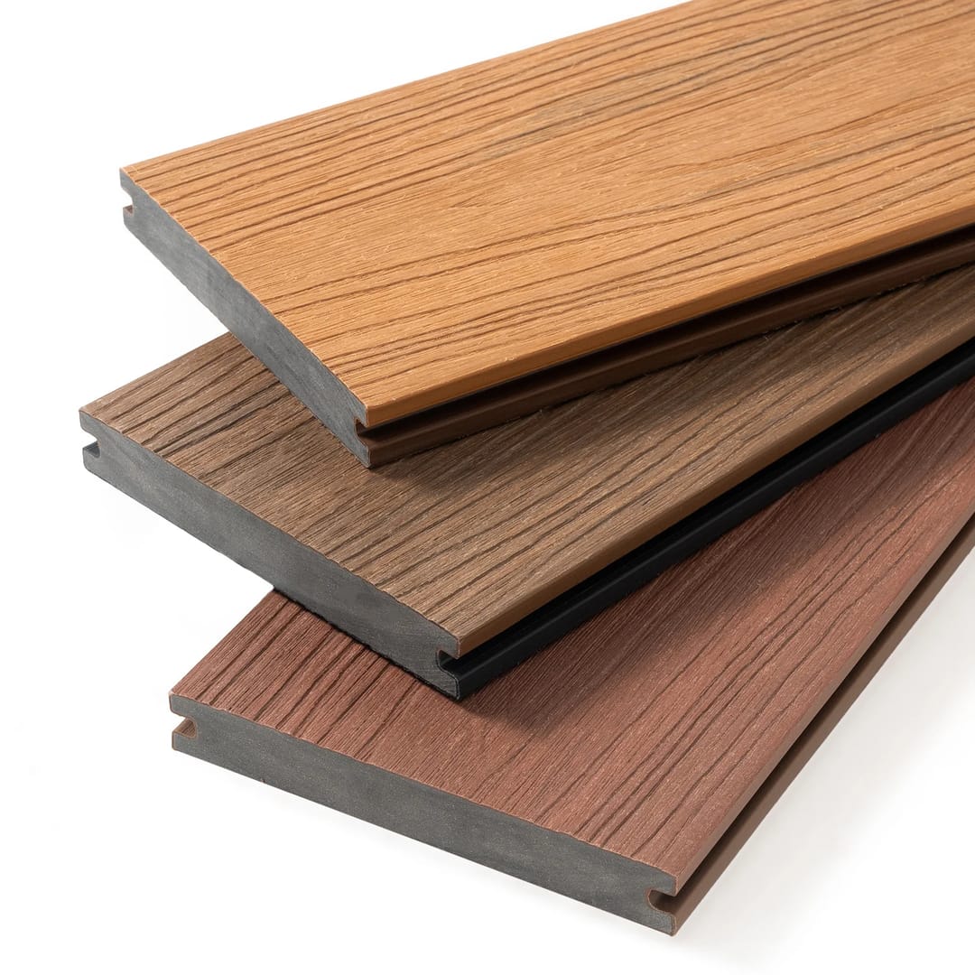 Three PureSolid Pro Solid co-extruded boards stacked to show solid cores and capped grain in orange, brown and red tones