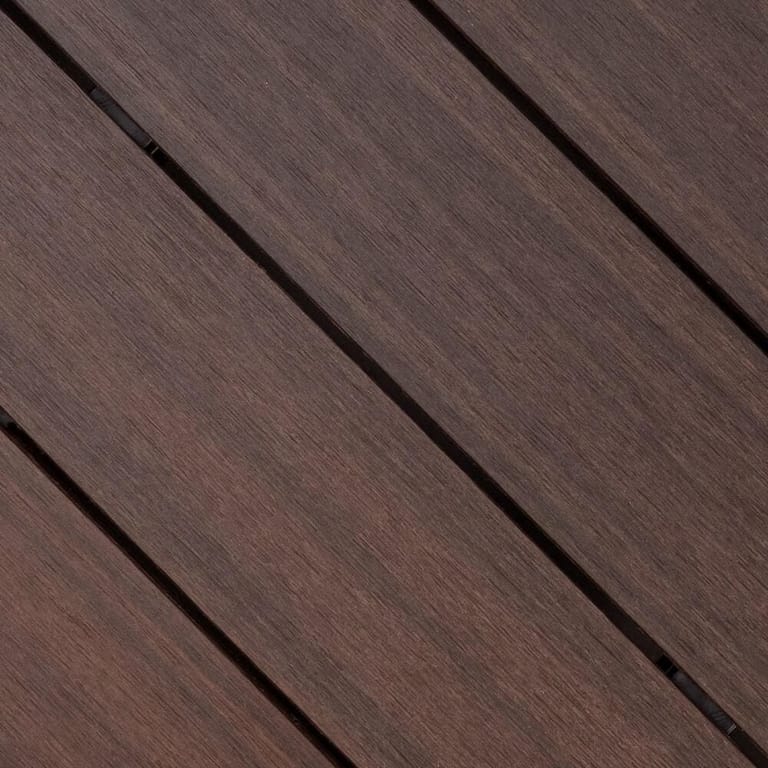 Close-up of Outdure ResortDeck Sunset composite deck boards laid on the diagonal, in dark chocolate brown