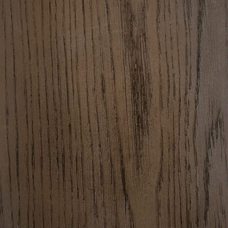 Full-frame close-up of an INNODECK board in Autumn Oak, a mid brown surface with deep embossed oak grain