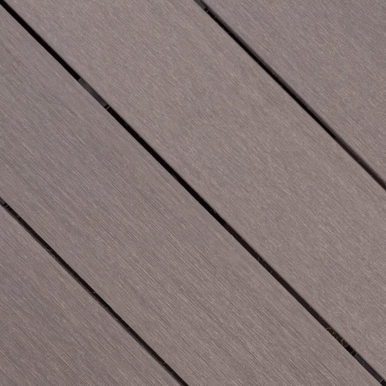Close-up of Outdure ResortDeck Storm composite deck boards laid on the diagonal, in mauve grey