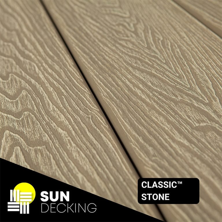 Angled close-up of Sun Decking Classic composite boards in Stone, a pale greige embossed woodgrain, with the Sun Decking logo in the corner