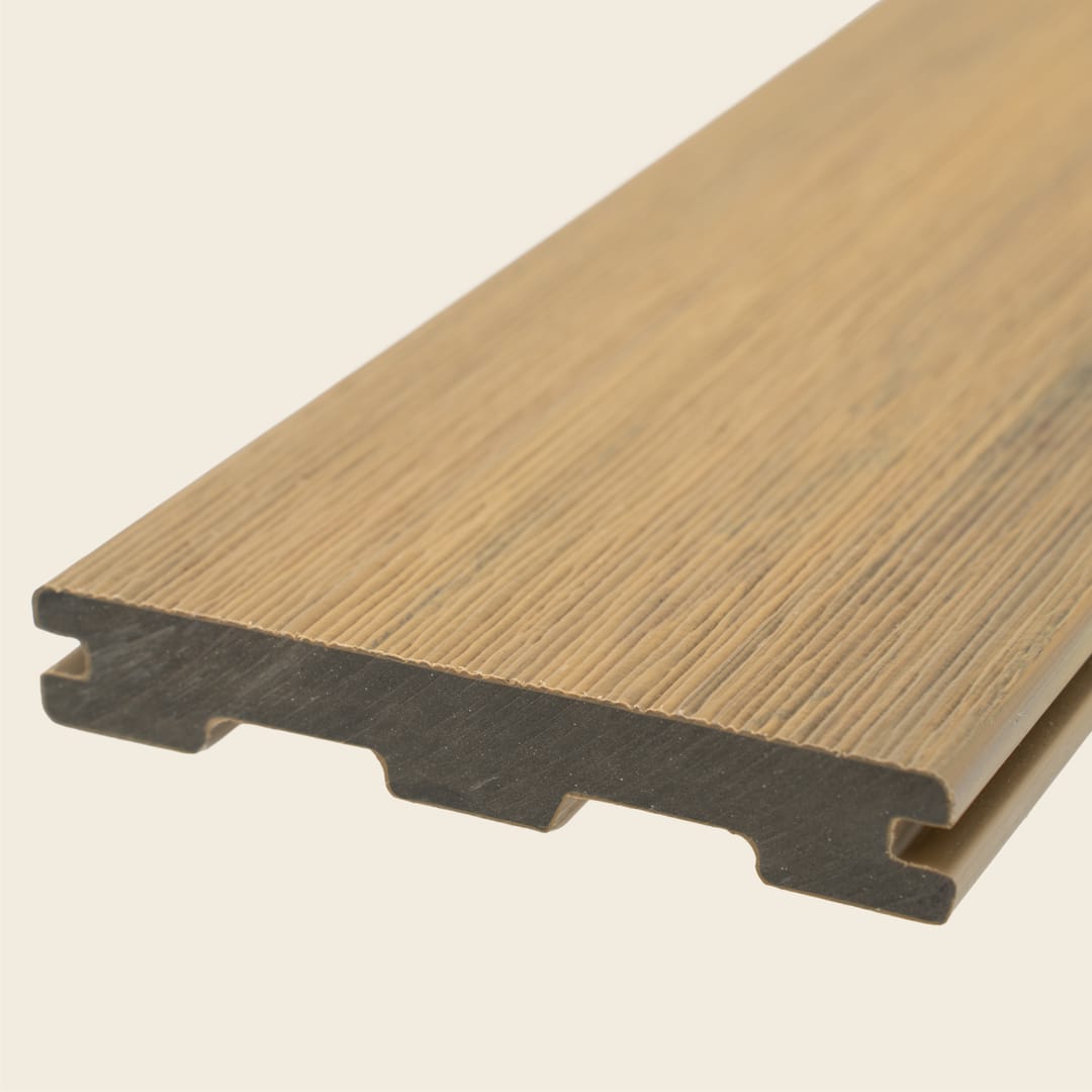 WoodEvo HOME grooved composite decking board in Nordic, a light golden timber tone, shown end-on on a cream background