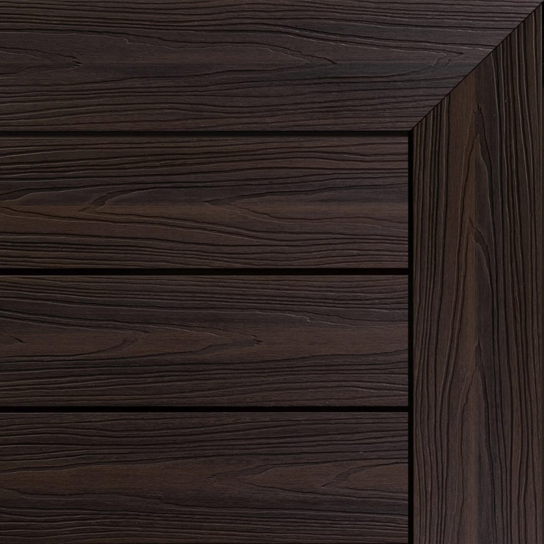 Ekodeck Flame Fighter composite decking boards in Deep Walnut, a dark brown, laid with an edge board