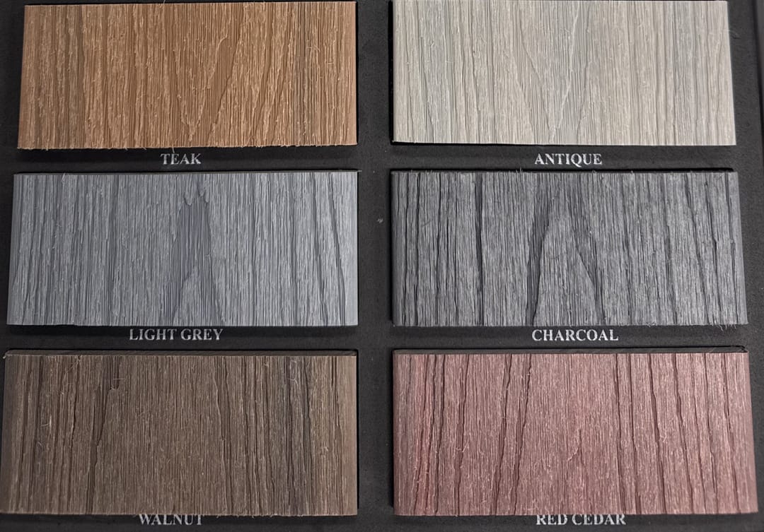 Acetech Decking colour chart: six labelled board samples in Teak, Antique, Light Grey, Charcoal, Walnut and Red Cedar on a black backing