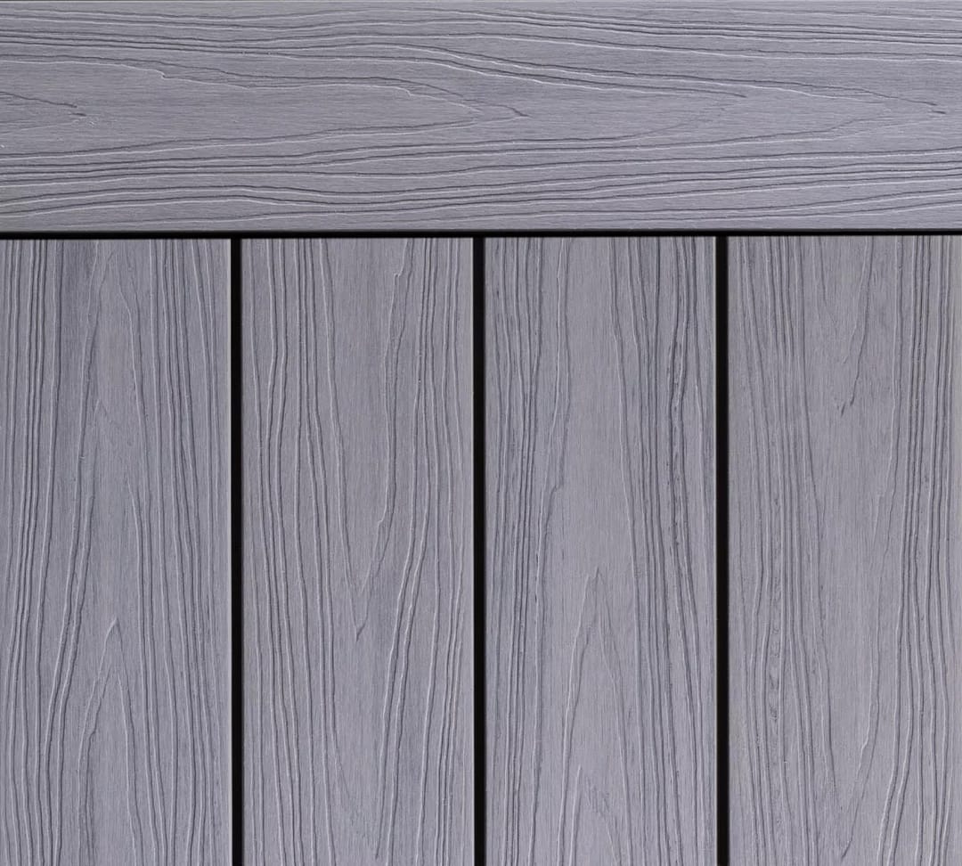 Ekodeck Designer Series composite decking boards in Alpine Ash, light grey with embossed grain and an edge board