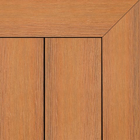 Close-up of Brite NextGen Titanium composite deck boards in Tawny, a warm caramel grain, with a mitred picture-frame corner