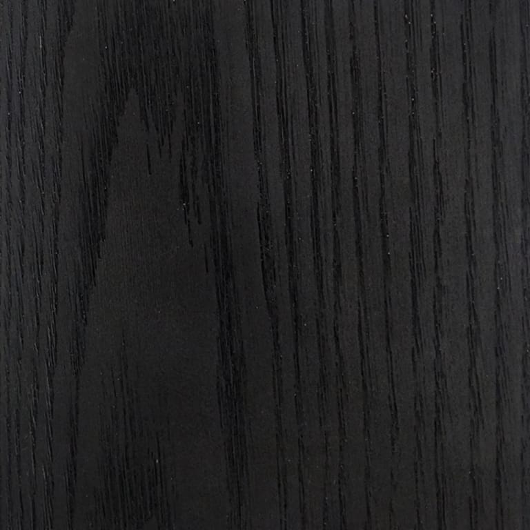 Full-frame close-up of an INNODECK board in Midnight Oak, a near-black surface with deep embossed oak grain