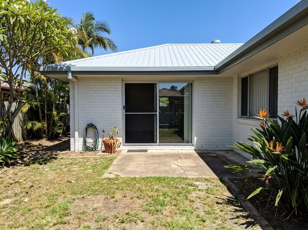 AI-generated photo of the back of a painted-brick lowset house in Brisbane, before the deck